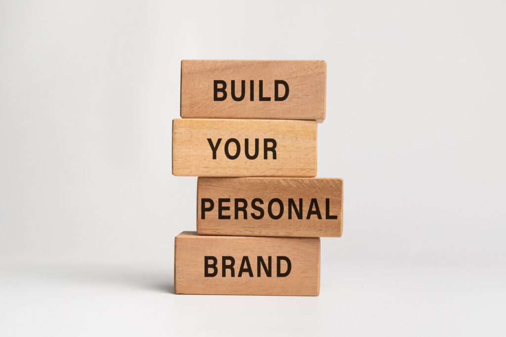 wooden blocks placed on top of each other, spelling out "build your personal brand"