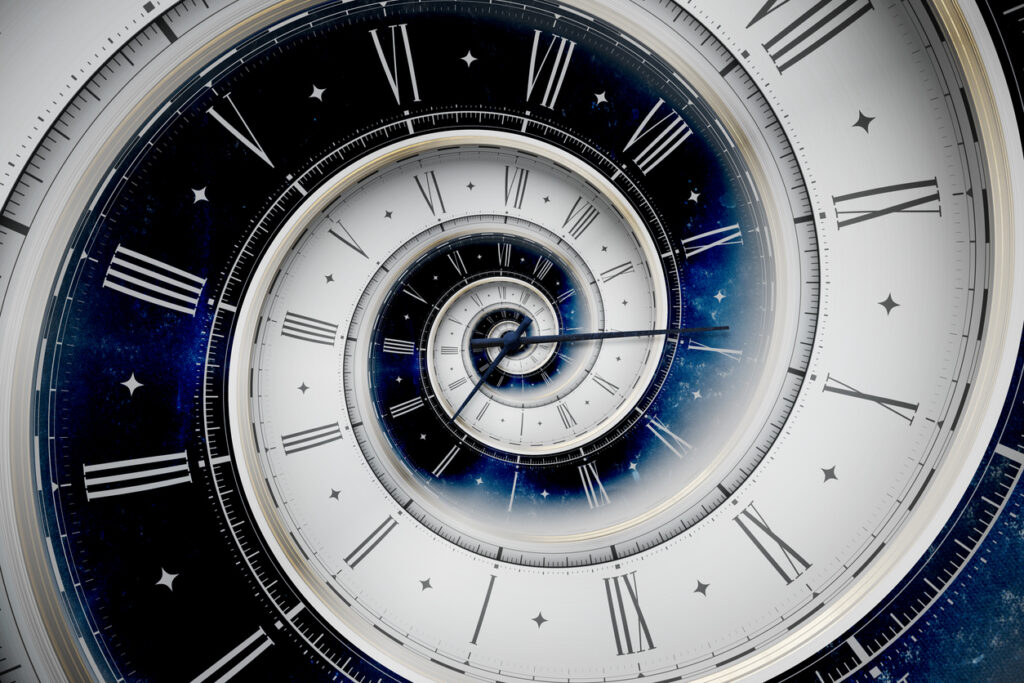 Vintage white spiral clock dial with roman numerals in white and blue colors. 